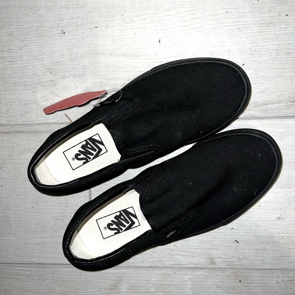 All black slip on vans
